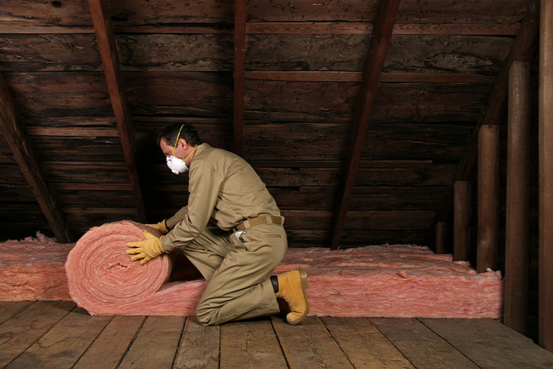 Tech installing insulation